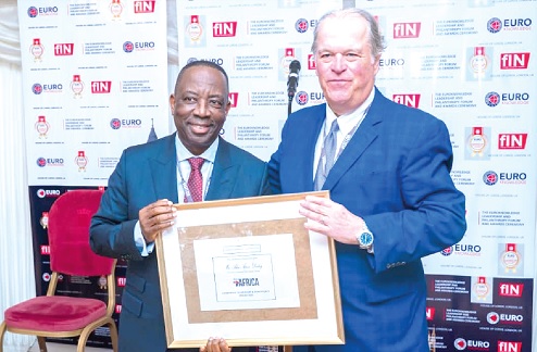 Alex Apau Dadey (left), Executive Chairman of KGL Group, receiving a citation from Mark A. Furlong of Forbes