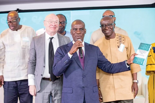 Haruna Iddrisu, Minister of Education, officially launching the book, while Prof. Kwame Akyeampong (right) and Dr Sean Higgins (2nd from left), co-authors of the book, look on
