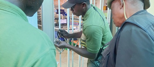 Members of the TDC Ghana Ltd Taskforce locking up the premises of a business indebted to the organisation