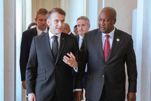 President Emmanuel Macron (left) in a discussion with President John Dramani Mahama during the meeting