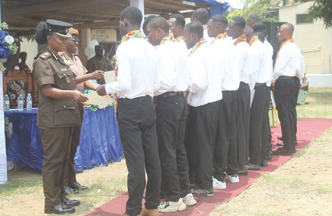 DPP Augustina Mensah-Fiadzo (left), Officer in Charge of James Camp Prison, presenting certificate to the graduates. Picture: ESTHER ADJORKOR ADJEI 