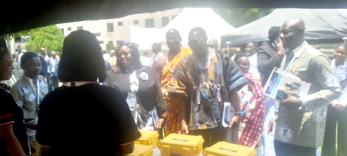 Bless Darkey  (in smock), acting Central Regional Coordinating Director, GhIS, with Dr Tina Wemegah, Chairman of the Lands Surveying Division, and other dignitaries at the exhibition after the opening of the conference