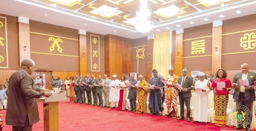 President Mahama (left) administering the oath of office to the new envoys
