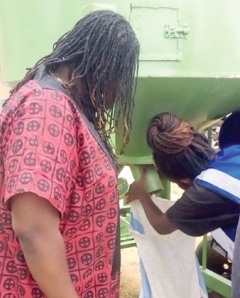 Victoria Amefadzi Yawa Doe, the DCE for North Tongu, observing the machines