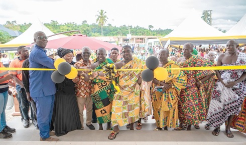 Kwabena Brempong Marfo (middle), , Board Chairman of the trust fund joined by officials to cut the tape to officially inaugurate the project