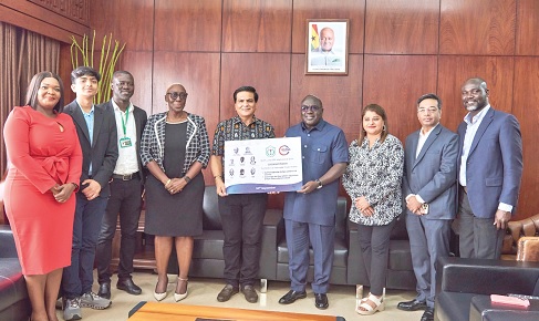 Mukesh Thakwani (5th from left), Chief Executive Officer, B5 Plus Limited, presenting the scholarship prototype to Julius Debrah (4th from right), Chief of Staff. With them are Marietta Brew (4th from left), Presidential Advisor on Legal Affairs, and some staff members of B5 Plus and DPS School