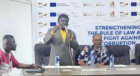 Godfred Owusu, the Fanteakwa North District Director of CHRAJ, delivering a speech at the programme