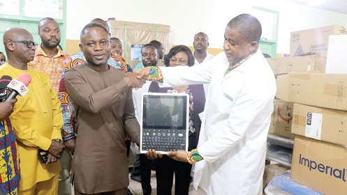 Kwabena Mintah-Akandoh, the Minister of Health, presenting medical equipment to the Ga North Municipal Hospital