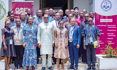 Prosper Bani (middle), National Security Advisor to President, and participants after the launch
