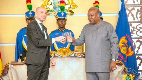 President Mahama proposing a toast with Jakob Linulf, Ambassador of Denmark
