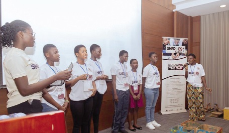 Participants from the smart house team demonstrating how their prototype uses sensors to control lighting and appliances