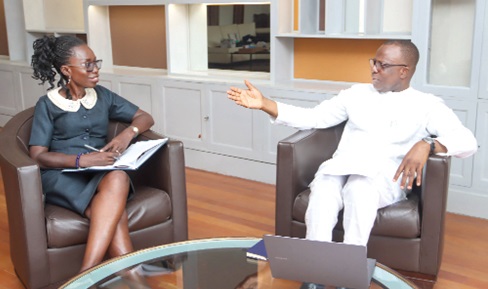 Jules Armand Aniambossou (right), former French Ambassador to Ghana, explaining a point to Rosalind Koramah Amoh, Sub-Editor, Daily Graphic. Picture: ELVIS NII NOI DOWUONA 