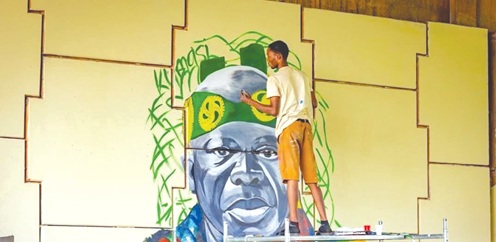 A student working on an artwork of the Asantehene, Otumfuo Osei Tutu II A student working on an artwork of the Asantehene, Otumfuo Osei Tutu II