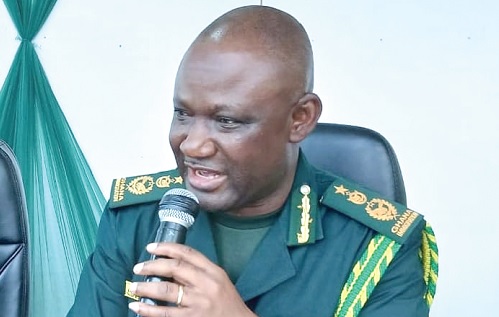 Samuel Basintale Amadu (right), Comptroller-General of Immigration, addressing the officers in Sunyani