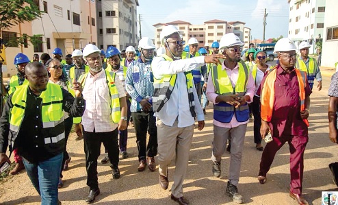 Courage Nunekpeku (with hand stretched), Managing Director of TDC Ghana Ltd, conducting Kenneth Gilbert Adjei (2nd from left), Minister of Works, Housing and Water Resources, round the buildings at the Kpone Affordable Housing Project site.