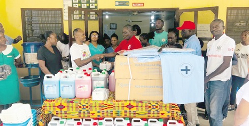 Apostle Henry Ampomah-Boateng (4th from right). founder of Global Peace Christian Centre handing over the items to Wisdom Acheampong (2nd from left), Administrator of the Abokobi Polyclinic