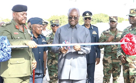 Dr Cassiel Ato Forson (middle), acting Minister of Defence, cutting the tape to inaugurate the Butler Barracks complex (inset), with support from Lt Gen. William Agyapong (left), Chief of the Defence Staff 