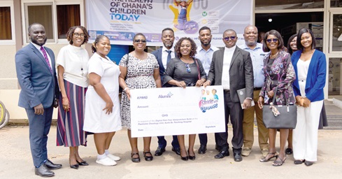 Joycelyn Coleman (4th from left), Partner and Head of Corporate Affairs, KPMG, and other officials from KPMG Alumni with health personnel from the Department of Child Health of the Korle-Bu Teaching Hospital after the presentation of the dummy cheque