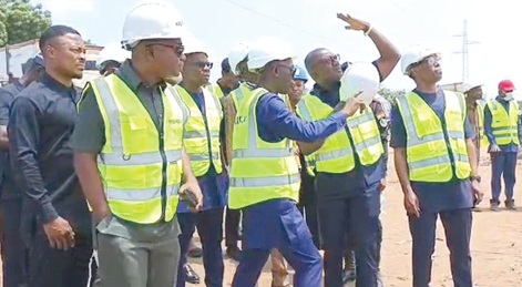 Dr John Abdulai Jinapor (with hand raised) being briefed by officials of GRIDCo on the extent of damage