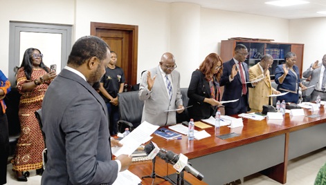 Dr Justice Srem-Sai (left), Deputy Attorney-General, guiding the board to affirm their official oath and oath of secrecy
