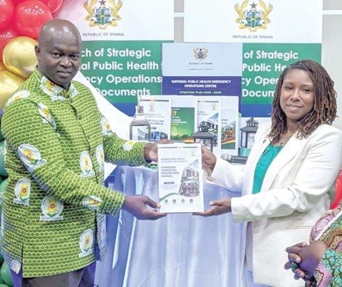 Dr Danielle Barradas (right), US CDC in Ghana, and Dr Samuel Kaba Akoriyea, Director-General of the Ghana Health Service,  launching the document for the strategic roadmap
