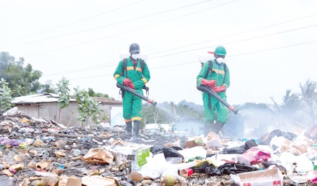 Some environmental officers spraying one of the locations. Some environmental officers spraying one of the locations.