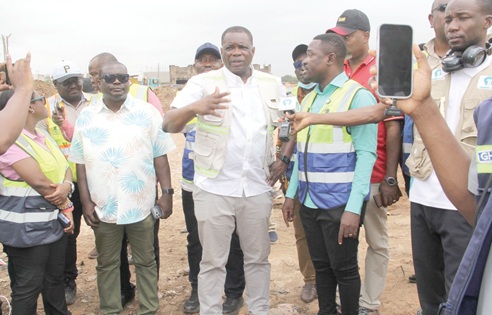 Governs Agbodza (middle), Minister of Roads and Highways, expressing his dissatisfaction to Oliver Acquah (2nd from right), CEO of First Sky Construction Limited, over the slow pace of work on the Tema Roundabout-Aflao road