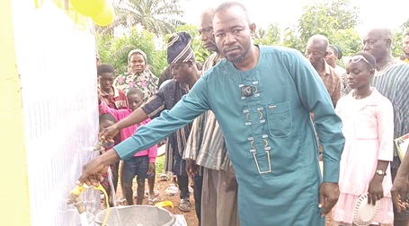 Haruna Abdul-Karim, District Chief Executive of Kpandai, inaugurating the mechanized water system at Kabonwuli