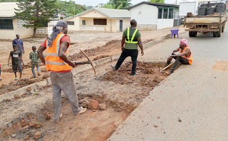 A group of workers patching potholes near the Ho Mawuli Estates A group of workers patching potholes near the Ho Mawuli Estates