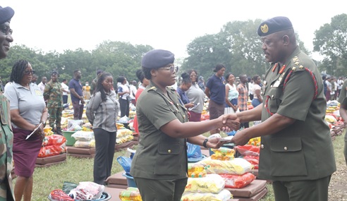Lt Gen. William Agyapong, Chief of the Defence Staff, making a presentation to one of the victims. Picture: BENEDICT OBUOBI