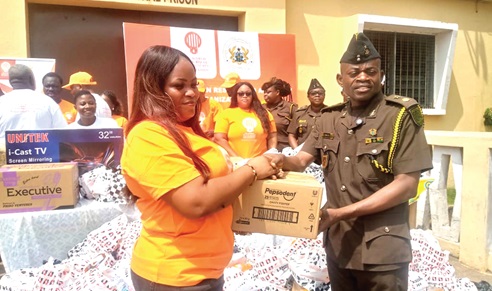 Delight Modzaka handling over some items to CSP Boakye after the inauguration