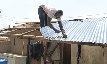 An affected person rebuilding his home after the storm An affected person rebuilding his home after the storm