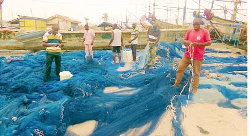 Some fisherfolk attending to their net
