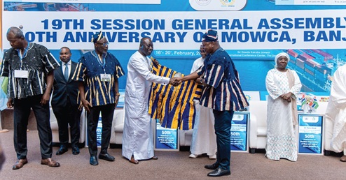 Joseph Nikpe (right), Minister of Transport, presenting a smock to Ebrima Sillah, Minister of Transport, Gambia. With them include Dr Kamal Deen Ali (3rd from left), Director-General, Ghana Maritime Authority 