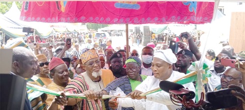 Samuuel Okudzeto Ablakwa (right), Foreign Affairs Minister, being supported by Akamugri Donatus Atanga (2nd from right), Upper East Regional Minister, and Tongraan Kugbilsong Nanlebegtang (2nd from left), the Paramount Chief of the Talensi Traditional Area, to cut the tape to inaugurate the passport application centre  