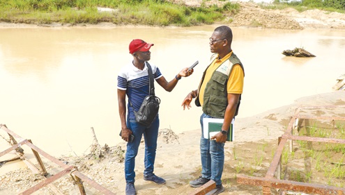Ernest Adofo, Manager, Bekwai Forest Services Division, explaining the devastation caused by illegal miners. Ernest Adofo, Manager, Bekwai Forest Services Division, explaining the devastation caused by illegal miners.