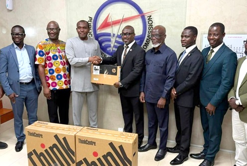 Dr Shafic Suleman (3rd from left), Executive Secretary, PURC, handing over laptop computers to Prof. Dennis Aheto (4th from right), Vice-Chancellor, UCC