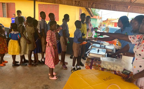 Some members of Ensuro Moa Kuo Foundation serving some of the orphans at the party at Oda Nkwanta