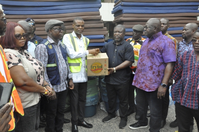 James Gunu (third, right), Volta Regional Minister, receiving the items from Paschal Agbagba, Volta Regional Director of NADMO while some DCEs look on