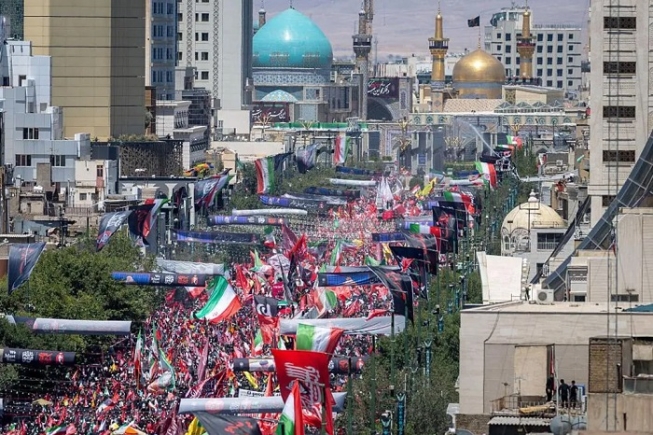 Crowds gathered on a boulevard in Mashhad leading to the gold-domed Imam Reza shrine