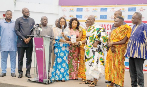 Abena Osei-Asare (4th from left), Chairperson, Public Accounts Committee of Parliament, being assisted by Togbe Atikpladza Agbi Yao VIII (3rd from right), Paramount Chief of Kpalime Traditional Area; Charles Akwasi Agbeve (3rd from left), Vice-Chairperson, Committee on Local Government and Rural Development; John Darko (2nd from left), Member of Parliament for Suame, and some dignitaries to launch the Public Financial Management Compliance League Table. Picture: ELVIS NII NOI DOWUONA