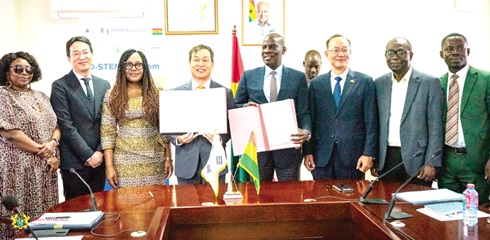 Haruna Iddrisu (5th from left), Minister of Education, and Gyongsig Park (4th from left), the Ambassador of the Republic of Korea to Ghana, displaying the signed documents. With them are officials of the GES and Korean Embassy