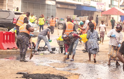 Police officers assist sanitation workers in desilting a storm drain during the clean-up at Accra Central, demonstrating inter-agency collaboration to improve sanitation and help prevent flooding. Pictures: CALEB VANDERPUYE Police officers assist sanitation workers in desilting a storm drain during the clean-up at Accra Central, demonstrating inter-agency collaboration to improve sanitation and help prevent flooding. Pictures: CALEB VANDERPUYE