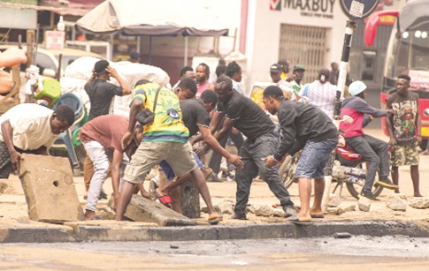 Residents and volunteers remove heavy concrete slabs and debris from a choked drain during the clean-up exercise at the Kwame Nkrumah Circle in Accra to improve drainage Residents and volunteers remove heavy concrete slabs and debris from a choked drain during the clean-up exercise at the Kwame Nkrumah Circle in Accra to improve drainage