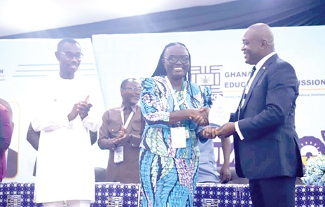 Prof. Ahmed Abdulai Jinapor (right), Director-General, Ghana Tertiary Education Commission, presenting a citation to Prof. Rita Akosua Dickson, Vice-Chansellor, KNUST, during the opening of the GTEC Summer School in Kumasi. Applauding is Ben Abdallah Alhassan (left), MCE for Asokore Mampong. Picture: EMMANUEL BAAH