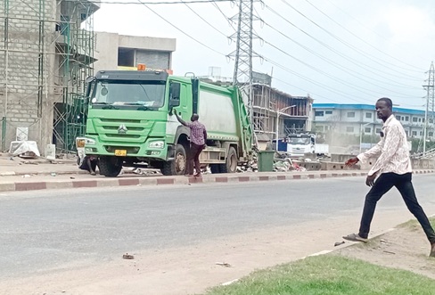 A waste truck loading garbage after the clean-up exercise