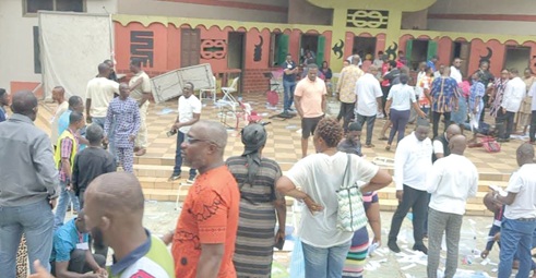 Some party members in Bantama observing the situation in disbelief after the destruction of the electoral materials (left)
