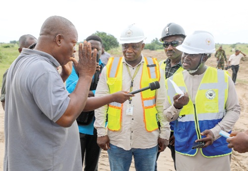 Maxwell Yao Akpene Klu (right), Deputy Chief Executive Officer of Small Scale and Industrial Minerals, Minerals Commission, questionining a tipper truck driver found transporting sand from an illegal sand-winning site at Tsopoli. Picture: ELVIS NII NOI DOWUONA 