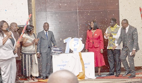 Dr William Adum Addo (4th from left), President, PIWA, Patience Tsegah (3rd from right), Vice President, PIWA, with some members of the association after unveiling the anniversary logo
