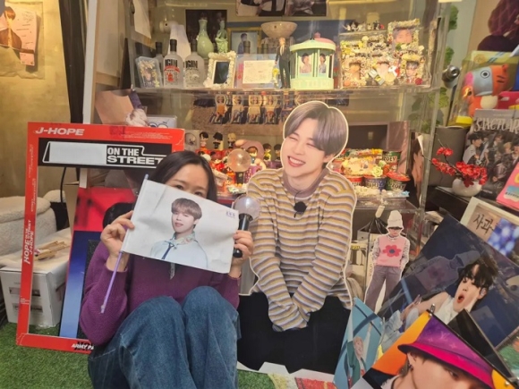 Yeon-su, pictured here at a BTS-themed café in Seoul, had not heard South Korean music before leaving her country